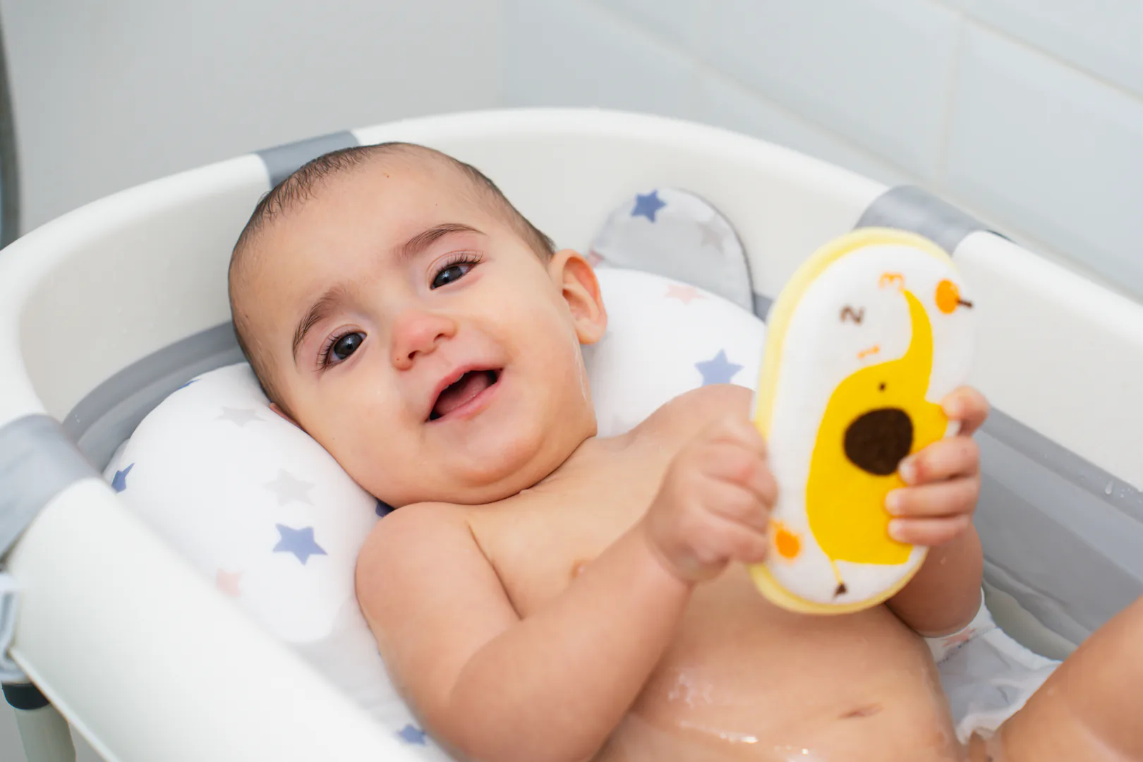 Bebé utilizando un cojín de bañera
